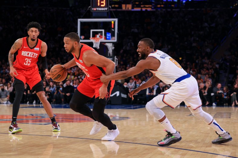 Nov 20, 2021; New York, New York, USA; Houston Rockets guard Eric Gordon (10) drives to the basket as New York Knicks guard Kemba Walker (8) defends in front of center Christian Wood (35) during the first half at Madison Square Garden. Mandatory Credit: Vincent Carchietta-USA TODAY Sports