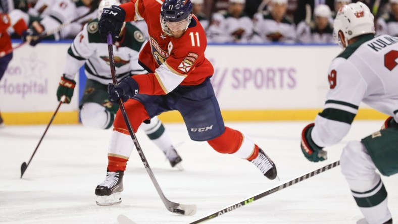 Nov 20, 2021; Sunrise, Florida, USA; Florida Panthers left wing Jonathan Huberdeau (11) shoots the puck against the Minnesota Wild during the third period at FLA Live Arena. Mandatory Credit: Sam Navarro-USA TODAY Sports