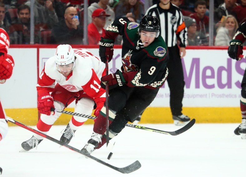 Nov 20, 2021; Glendale, Arizona, USA; Arizona Coyotes right wing Clayton Keller (9) moves the puck against the Detroit Red Wings in the second period at Gila River Arena. Mandatory Credit: Mark J. Rebilas-USA TODAY Sports