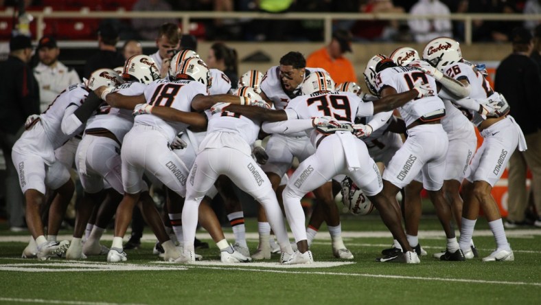 Nov 20, 2021; Lubbock, Texas, USA;  The Oklahoma State Cowboys huddle before a game against the Texas Tech Red Raiders at Jones AT&T Stadium. Mandatory Credit: Michael C. Johnson-USA TODAY Sports