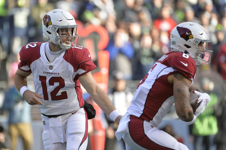 Nov 21, 2021; Seattle, Washington, USA; 
Arizona Cardinals quarterback Colt McCoy (12) hands the ball off to Arizona Cardinals running back James Conner (6) during the first half against the Seattle Seahawks at Lumen Field. Mandatory Credit: Steven Bisig-USA TODAY Sports