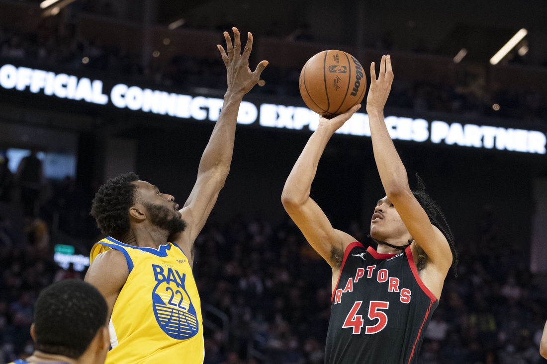 November 21, 2021; San Francisco, California, USA; Toronto Raptors guard Dalano Banton (45) shoots the basketball against Golden State Warriors forward Andrew Wiggins (22) during the second quarter at Chase Center. Mandatory Credit: Kyle Terada-USA TODAY Sports