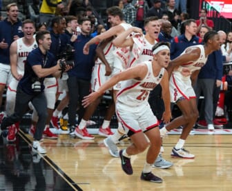 Nov 21, 2021; Las Vegas, Nevada, USA; Arizona Wildcats players storm the court after defeating the Michigan Wolverines 80-62 to win the Roman Main Event Championship game at T-Mobile Arena. Mandatory Credit: Stephen R. Sylvanie-USA TODAY Sports