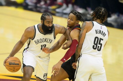 Nov 22, 2021; Cleveland, Ohio, USA; Cleveland Cavaliers guard Darius Garland (10) defends Brooklyn Nets guard James Harden (13) and guard DeAndre' Bembry (95) in the first quarter at Rocket Mortgage FieldHouse. Mandatory Credit: David Richard-USA TODAY Sports