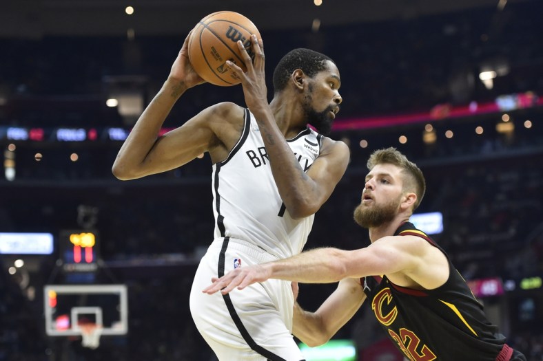 Nov 22, 2021; Cleveland, Ohio, USA; Cleveland Cavaliers forward Dean Wade (32) defends Brooklyn Nets forward Kevin Durant (7) in the second quarter at Rocket Mortgage FieldHouse. Mandatory Credit: David Richard-USA TODAY Sports