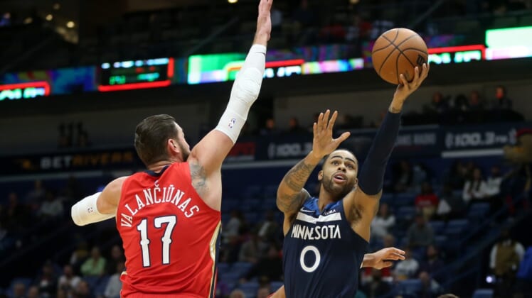 Nov 22, 2021; New Orleans, Louisiana, USA; Minnesota Timberwolves guard D'Angelo Russell (0) shoots while defended by New Orleans Pelicans center Jonas Valanciunas (17) in the first quarter at the Smoothie King Center. Mandatory Credit: Chuck Cook-USA TODAY Sports
