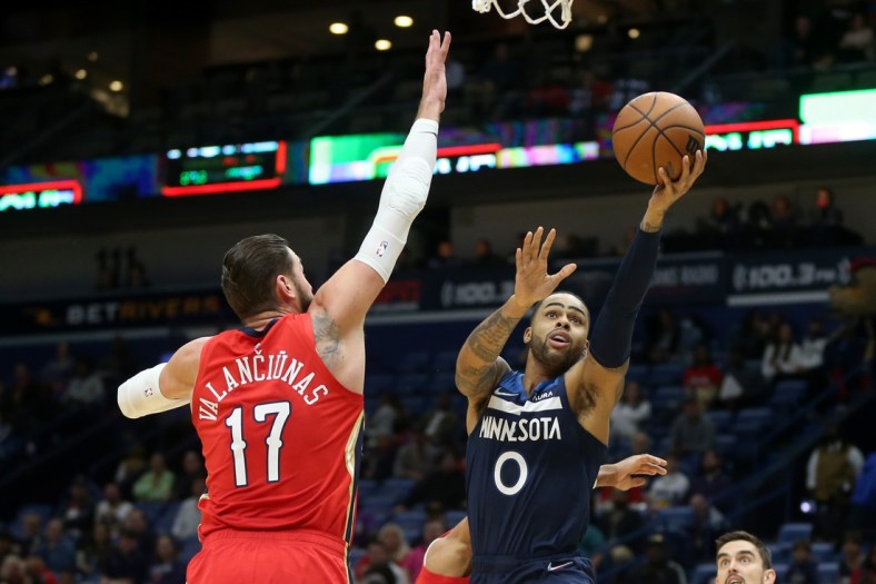Nov 22, 2021; New Orleans, Louisiana, USA; Minnesota Timberwolves guard D'Angelo Russell (0) shoots while defended by New Orleans Pelicans center Jonas Valanciunas (17) in the first quarter at the Smoothie King Center. Mandatory Credit: Chuck Cook-USA TODAY Sports