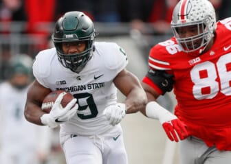 Michigan State running back Kenneth Walker III runs past Ohio State Buckeyes defensive tackle Jerron Cage during the first quarter at Ohio Stadium in Columbus, Ohio on Nov. 20, 2021.Syndication The Providence Journal