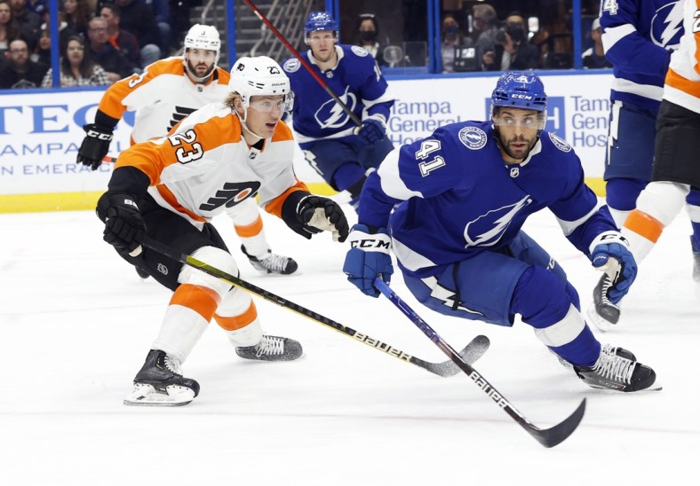 Nov 23, 2021; Tampa, Florida, USA; Tampa Bay Lightning center Pierre-Edouard Bellemare (41) and Philadelphia Flyers left wing Oskar Lindblom (23) skate after the puck during the first period at Amalie Arena. Mandatory Credit: Kim Klement-USA TODAY Sports