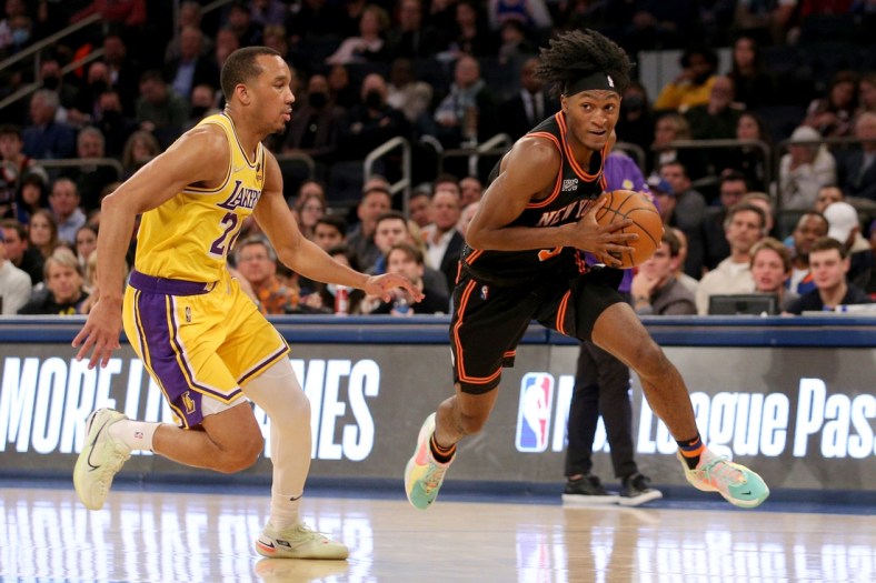 Nov 23, 2021; New York, New York, USA; New York Knicks guard Immanuel Quickley (5) drives to the basket around Los Angeles Lakers guard Avery Bradley (20) during the fourth quarter at Madison Square Garden. Mandatory Credit: Brad Penner-USA TODAY Sports