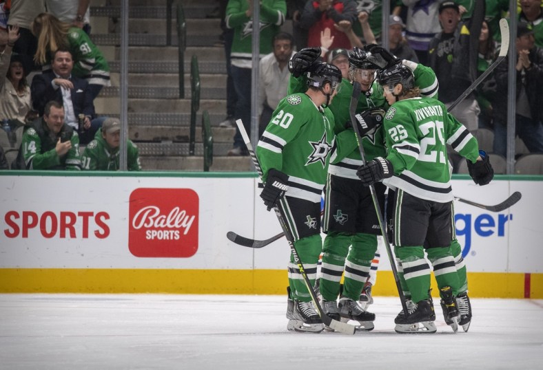 Nov 23, 2021; Dallas, Texas, USA; Dallas Stars defenseman Ryan Suter (20) and center Radek Faksa (12) and left wing Joel Kiviranta (25) and center Luke Glendening (11) celebrates a goal scored by Glendening against the Edmonton Oilers during the third period at the American Airlines Center. Mandatory Credit: Jerome Miron-USA TODAY Sports