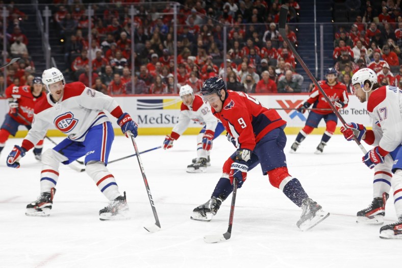 Nov 24, 2021; Washington, District of Columbia, USA; Washington Capitals defenseman Dmitry Orlov (9) skates with the puck as Montreal Canadiens defenseman Jeff Petry (26) during the first period at Capital One Arena. Mandatory Credit: Geoff Burke-USA TODAY Sports