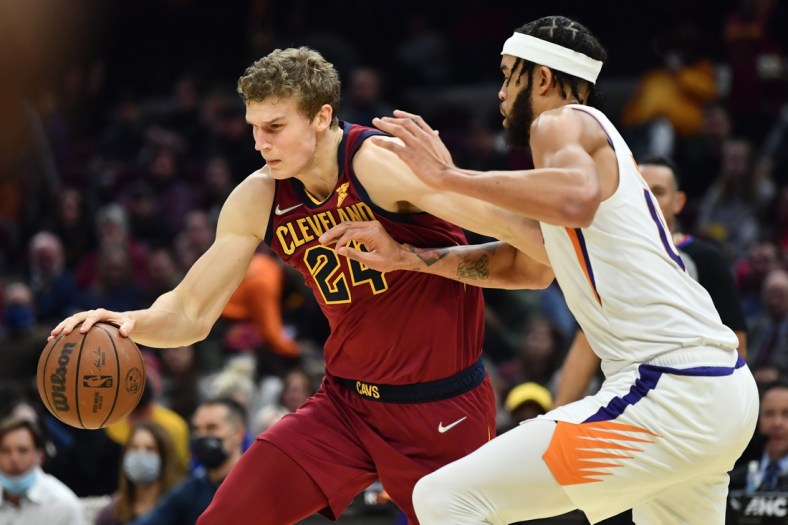 Nov 24, 2021; Cleveland, Ohio, USA; Cleveland Cavaliers forward Lauri Markkanen (24) drives to the basket against Phoenix Suns center JaVale McGee (00) during the first half at Rocket Mortgage FieldHouse. Mandatory Credit: Ken Blaze-USA TODAY Sports