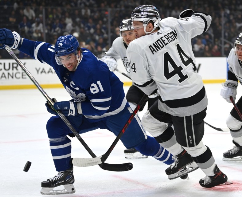 Nov 24, 2021; Los Angeles, California, USA; Toronto Maple Leafs center John Tavares (91) and Los Angeles Kings defenseman Mikey Anderson (44) battle for the puck in the first period at Staples Center. Mandatory Credit: Jayne Kamin-Oncea-USA TODAY Sports