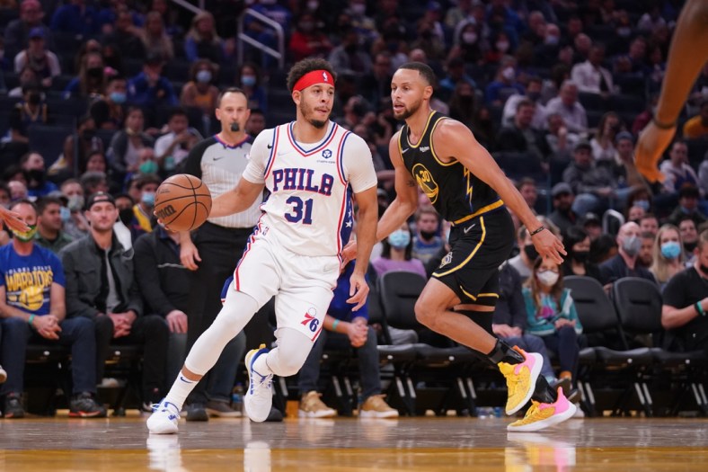 Nov 24, 2021; San Francisco, California, USA; Philadelphia 76ers guard Seth Curry (31) dribbles the ball next to Golden State Warriors guard Stephen Curry (30) in the second quarter at the Chase Center. Mandatory Credit: Cary Edmondson-USA TODAY Sports