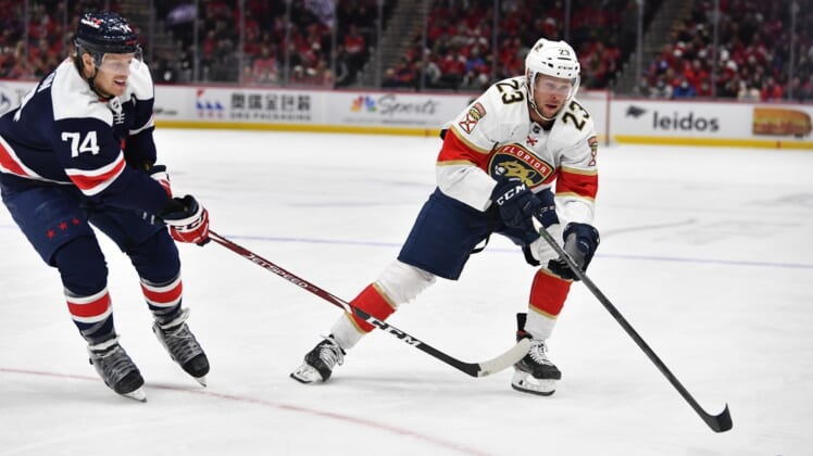 Nov 26, 2021; Washington, District of Columbia, USA; Florida Panthers left wing Carter Verhaeghe (23) carries the puck as Washington Capitals defenseman John Carlson (74) defends during the first period at Capital One Arena. Mandatory Credit: Brad Mills-USA TODAY Sports