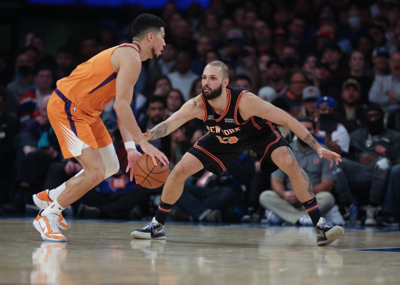 Nov 26, 2021; New York, New York, USA; New York Knicks guard Evan Fournier (13) defends as Phoenix Suns guard Devin Booker (1) dribbles during the first half at Madison Square Garden. Mandatory Credit: Vincent Carchietta-USA TODAY Sports