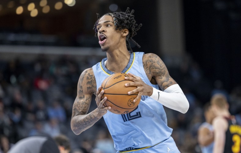 Nov 26, 2021; Memphis, Tennessee, USA; Memphis Grizzlies guard Ja Morant (12) holds the ball before tip off of the first half of a game against the Atlanta Hawks at FedExForum. Morant was injured early in the first quarter. Mandatory Credit: Vasha Hunt-USA TODAY Sports