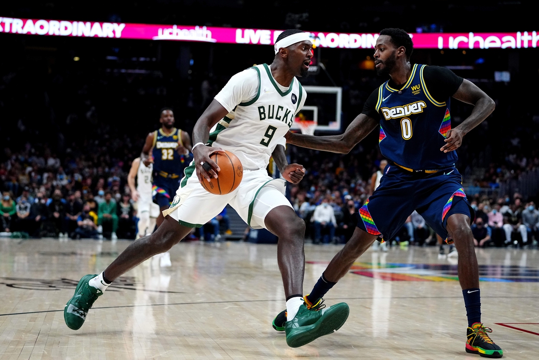 Nov 26, 2021; Denver, Colorado, USA; Milwaukee Bucks center Bobby Portis (9) drives at Denver Nuggets forward JaMychal Green (0) in the second quarter at Ball Arena. Mandatory Credit: Ron Chenoy-USA TODAY Sports