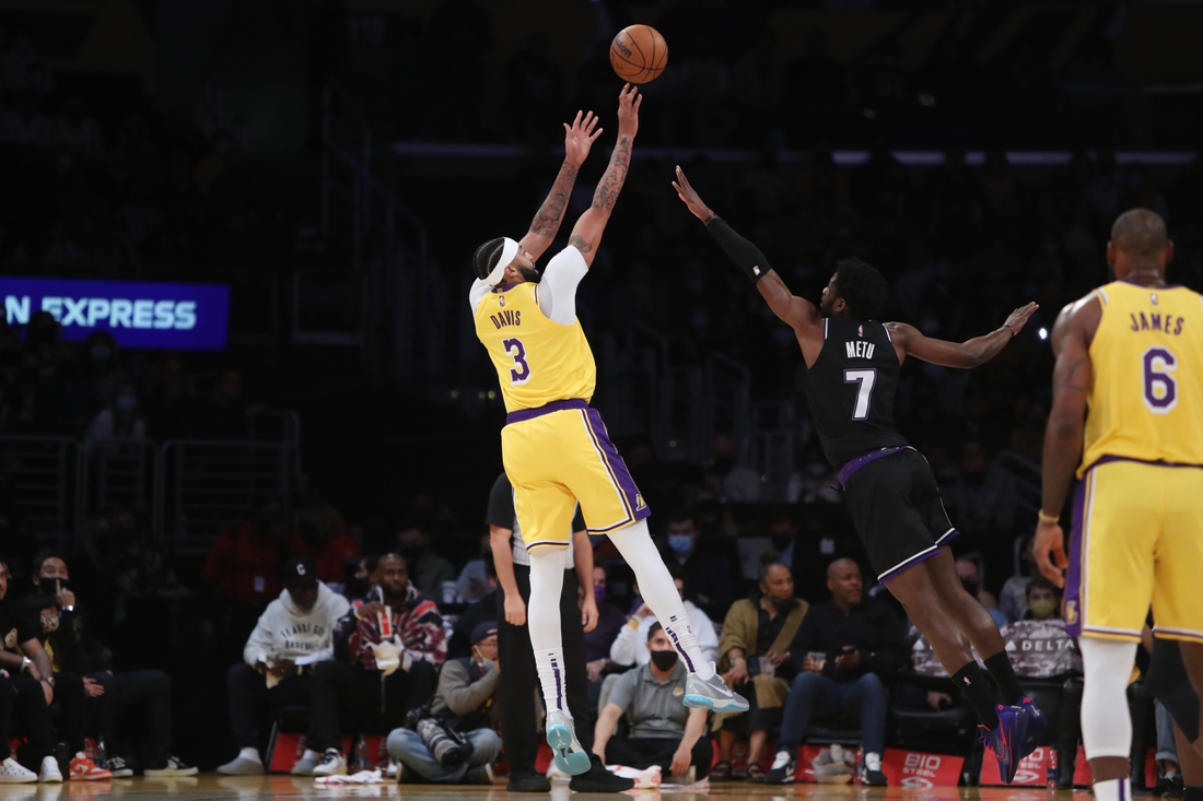 Nov 26, 2021; Los Angeles, California, USA; Los Angeles Lakers forward Anthony Davis (3) shoots a ball over Sacramento Kings forward Chimezie Metu (7) during the first quarter at Staples Center. Mandatory Credit: Kiyoshi Mio-USA TODAY Sports