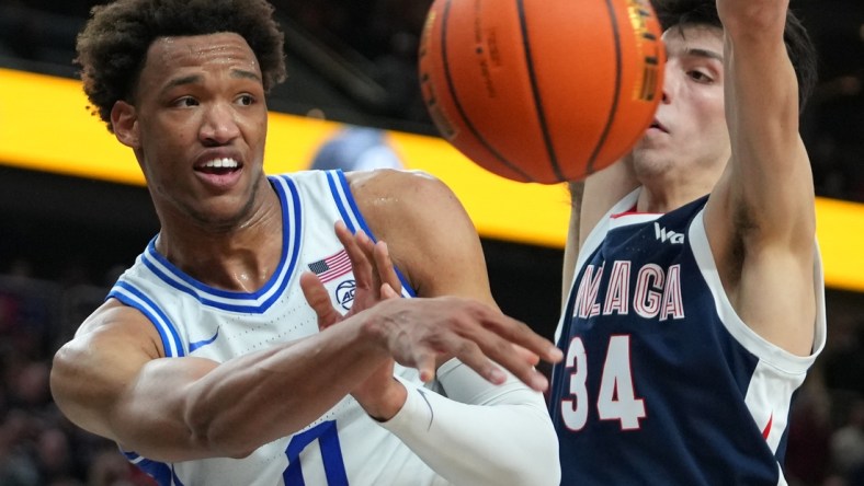 Nov 26, 2021; Las Vegas, Nevada, USA; Duke Blue Devils forward Wendell Moore Jr. (0) makes a pass under the basket as Gonzaga Bulldogs center Chet Holmgren (34) defends the basket during the second half at T-Mobile Arena. Mandatory Credit: Stephen R. Sylvanie-USA TODAY Sports