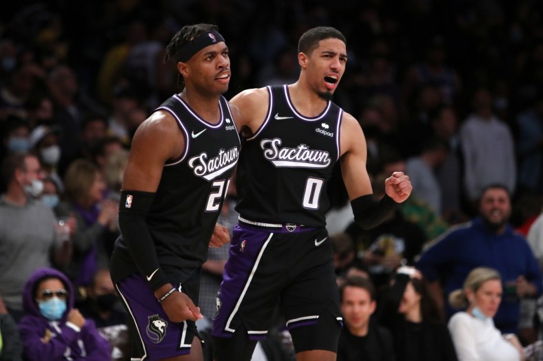 Nov 26, 2021; Los Angeles, California, USA; Sacramento Kings guard Tyrese Haliburton (0) celebrates with guard Buddy Hield (24) after Hield scored a basket in the first overtime against the Los Angeles Lakers at Staples Center. The Kings won 141-137 in triple-overtime. Mandatory Credit: Kiyoshi Mio-USA TODAY Sports