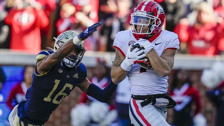 Nov 27, 2021; Atlanta, Georgia, USA; Georgia Bulldogs wide receiver Jermaine Burton (7) catches a touchdown pass behind Georgia Tech Yellow Jackets defensive back Myles Sims (16) during the first quarter at Bobby Dodd Stadium. Mandatory Credit: Dale Zanine-USA TODAY Sports