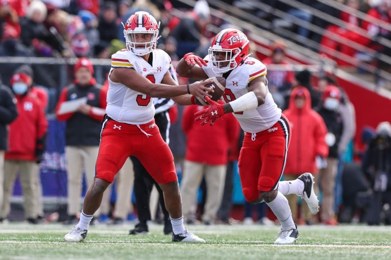 Nov 27, 2021; Piscataway, New Jersey, USA; Maryland Terrapins quarterback Taulia Tagovailoa (3) hands off to running back Tayon Fleet-Davis (8) against the Rutgers Scarlet Knights during the first half at SHI Stadium. Mandatory Credit: Vincent Carchietta-USA TODAY Sports