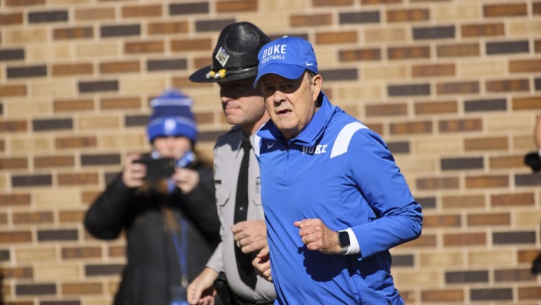 Nov 27, 2021; Durham, North Carolina, USA;  Duke Blue Devils head coach David Cutcliffe runs out during the first half of the game against the Miami Hurricanes at Wallace Wade Stadium. at Wallace Wade Stadium. Mandatory Credit: Jaylynn Nash-USA TODAY Sports