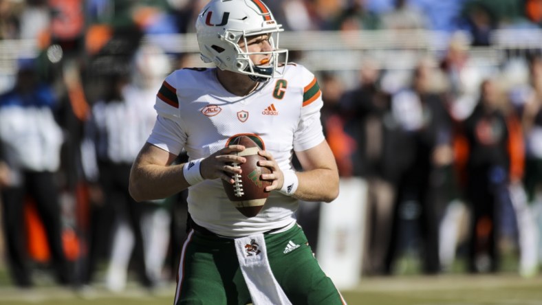 Nov 27, 2021; Durham, North Carolina, USA; Miami Hurricanes quarterback Tyler Van Dyke (9) with the ball during the first half of the game against the Miami Hurricanes at Wallace Wade Stadium. at Wallace Wade Stadium. Mandatory Credit: Jaylynn Nash-USA TODAY Sports