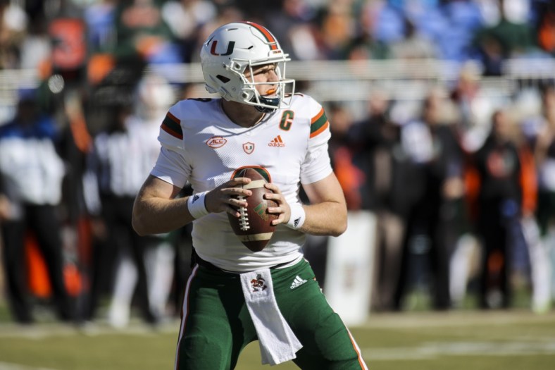 Nov 27, 2021; Durham, North Carolina, USA; Miami Hurricanes quarterback Tyler Van Dyke (9) with the ball during the first half of the game against the Miami Hurricanes at Wallace Wade Stadium. at Wallace Wade Stadium. Mandatory Credit: Jaylynn Nash-USA TODAY Sports