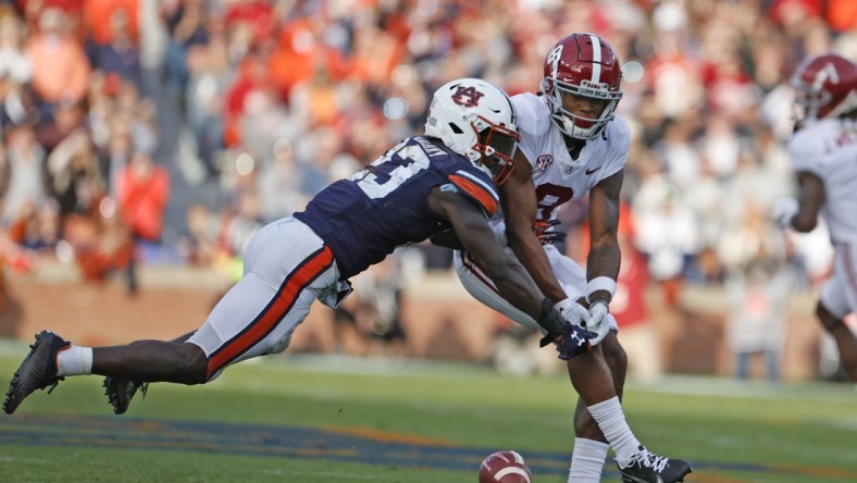 Nov 27, 2021; Auburn, Alabama, USA;  Auburn Tigers cornerback Roger McCreary (23) breaks up a pass intended for Alabama Crimson Tide wide receiver John Metchie III (8) during the second quarter at Jordan-Hare Stadium. Mandatory Credit: John Reed-USA TODAY Sports