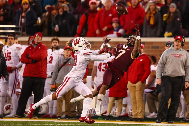 Nov 27, 2021; Minneapolis, Minnesota, USA; Wisconsin Badgers cornerback Alexander Smith (11) breaks up a pass intended for Minnesota Gophers wide receiver Chris Autman-Bell (7) during the second quarter at Huntington Bank Stadium. Mandatory Credit: Harrison Barden-USA TODAY Sports