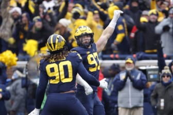 Nov 27, 2021; Ann Arbor, Michigan, USA; Michigan Wolverines defensive end Aidan Hutchinson (97) celebrates his sad of Ohio State Buckeyes quarterback C.J. Stroud (not pictured) with defensive end Mike Morris (90) in the second half in the second half at Michigan Stadium. Mandatory Credit: Rick Osentoski-USA TODAY Sports