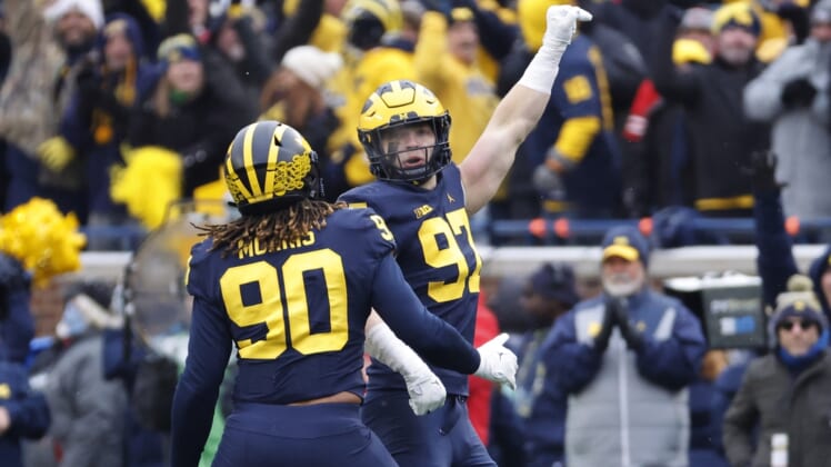 Nov 27, 2021; Ann Arbor, Michigan, USA; Michigan Wolverines defensive end Aidan Hutchinson (97) celebrates his sad of Ohio State Buckeyes quarterback C.J. Stroud (not pictured) with defensive end Mike Morris (90) in the second half in the second half at Michigan Stadium. Mandatory Credit: Rick Osentoski-USA TODAY Sports