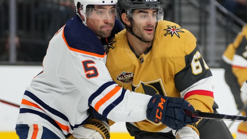 Nov 27, 2021; Las Vegas, Nevada, USA; Edmonton Oilers defenseman Cody Ceci (5) covers Vegas Golden Knights left wing Max Pacioretty (67) during the first period at T-Mobile Arena. Mandatory Credit: Stephen R. Sylvanie-USA TODAY Sports