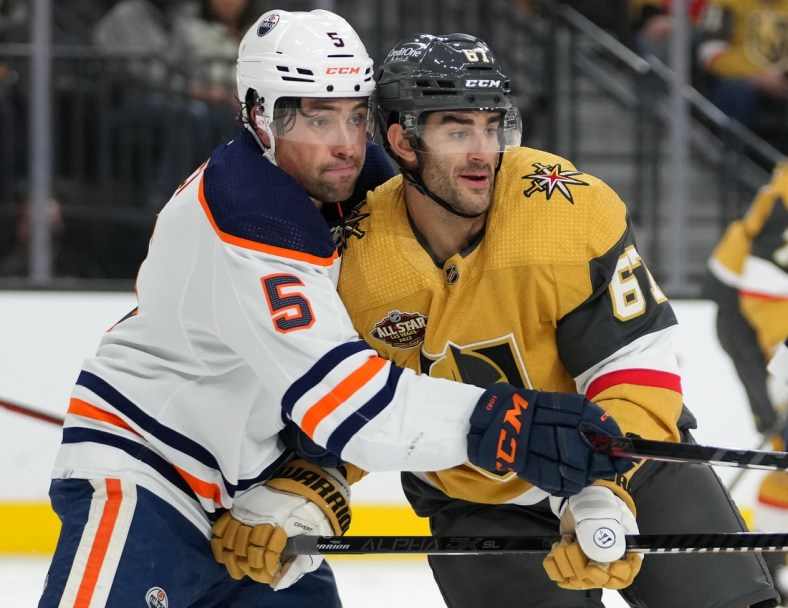 Nov 27, 2021; Las Vegas, Nevada, USA; Edmonton Oilers defenseman Cody Ceci (5) covers Vegas Golden Knights left wing Max Pacioretty (67) during the first period at T-Mobile Arena. Mandatory Credit: Stephen R. Sylvanie-USA TODAY Sports