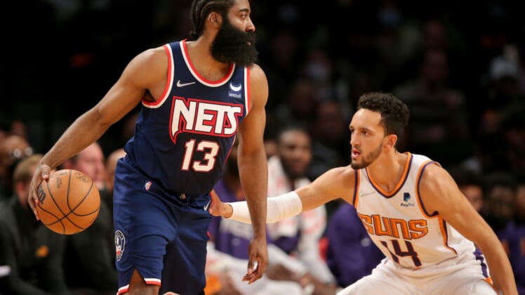 Nov 27, 2021; Brooklyn, New York, USA; Brooklyn Nets guard James Harden (13) controls the ball against Phoenix Suns guard Landry Shamet (14) during the second quarter at Barclays Center. Mandatory Credit: Brad Penner-USA TODAY Sports