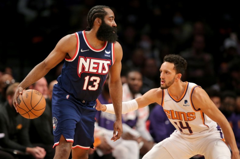 Nov 27, 2021; Brooklyn, New York, USA; Brooklyn Nets guard James Harden (13) controls the ball against Phoenix Suns guard Landry Shamet (14) during the second quarter at Barclays Center. Mandatory Credit: Brad Penner-USA TODAY Sports