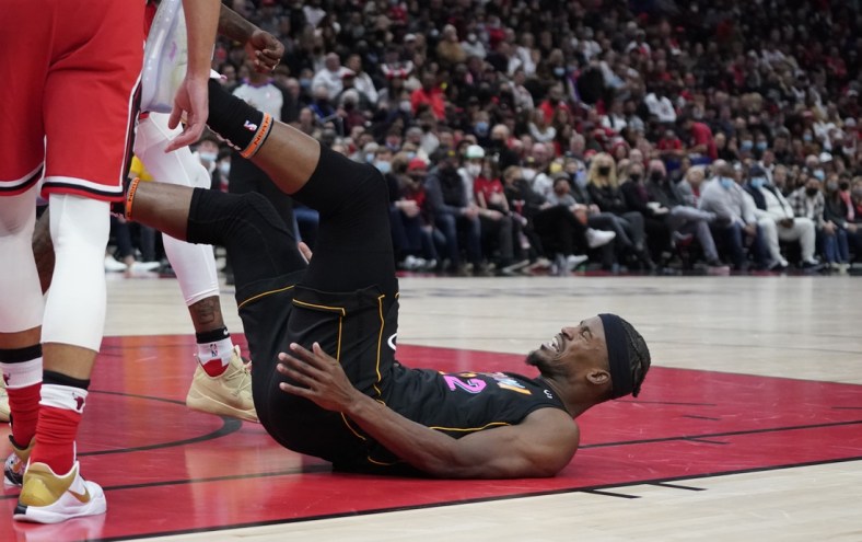 Nov 27, 2021; Chicago, Illinois, USA; Miami Heat forward Jimmy Butler (22) falls to the ground after being fouled against the Chicago Bulls during the second half at United Center. Mandatory Credit: David Banks-USA TODAY Sports