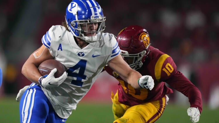Nov 27, 2021; Los Angeles, California, USA; BYU Cougars running back Lopini Katoa (4) runs the ball against Southern California Trojans linebacker Ralen Goforth (10) in the first half at United Airlines Field at Los Angeles Memorial Coliseum. Mandatory Credit: Kirby Lee-USA TODAY Sports