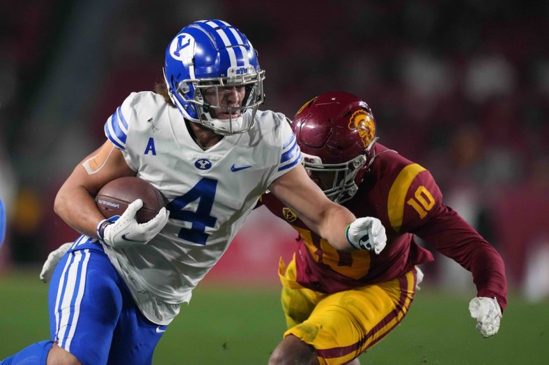 Nov 27, 2021; Los Angeles, California, USA; BYU Cougars running back Lopini Katoa (4) runs the ball against Southern California Trojans linebacker Ralen Goforth (10) in the first half at United Airlines Field at Los Angeles Memorial Coliseum. Mandatory Credit: Kirby Lee-USA TODAY Sports