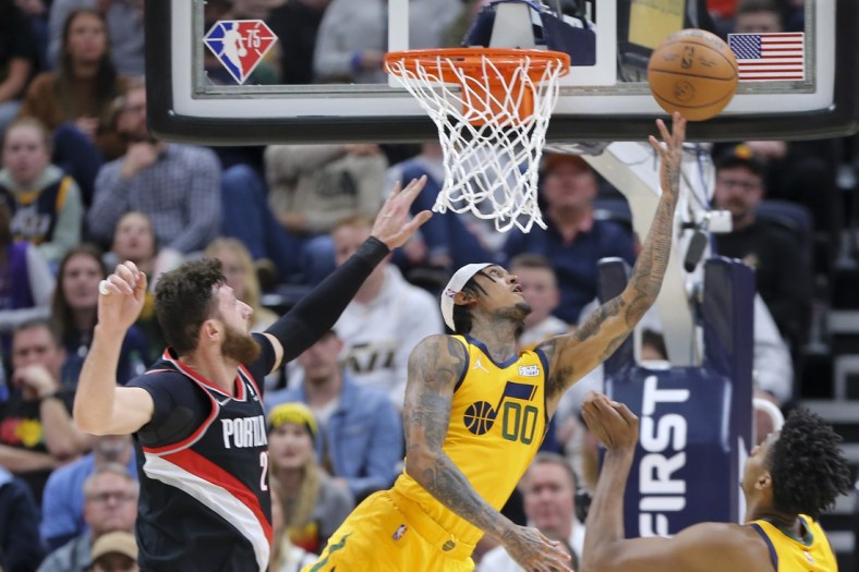Nov 29, 2021; Salt Lake City, Utah, USA; Utah Jazz guard Jordan Clarkson (00) is fouled by Portland Trail Blazers center Jusuf Nurkic (27) as he attempts a layup during the second quarter at Vivint Arena. Mandatory Credit: Rob Gray-USA TODAY Sports