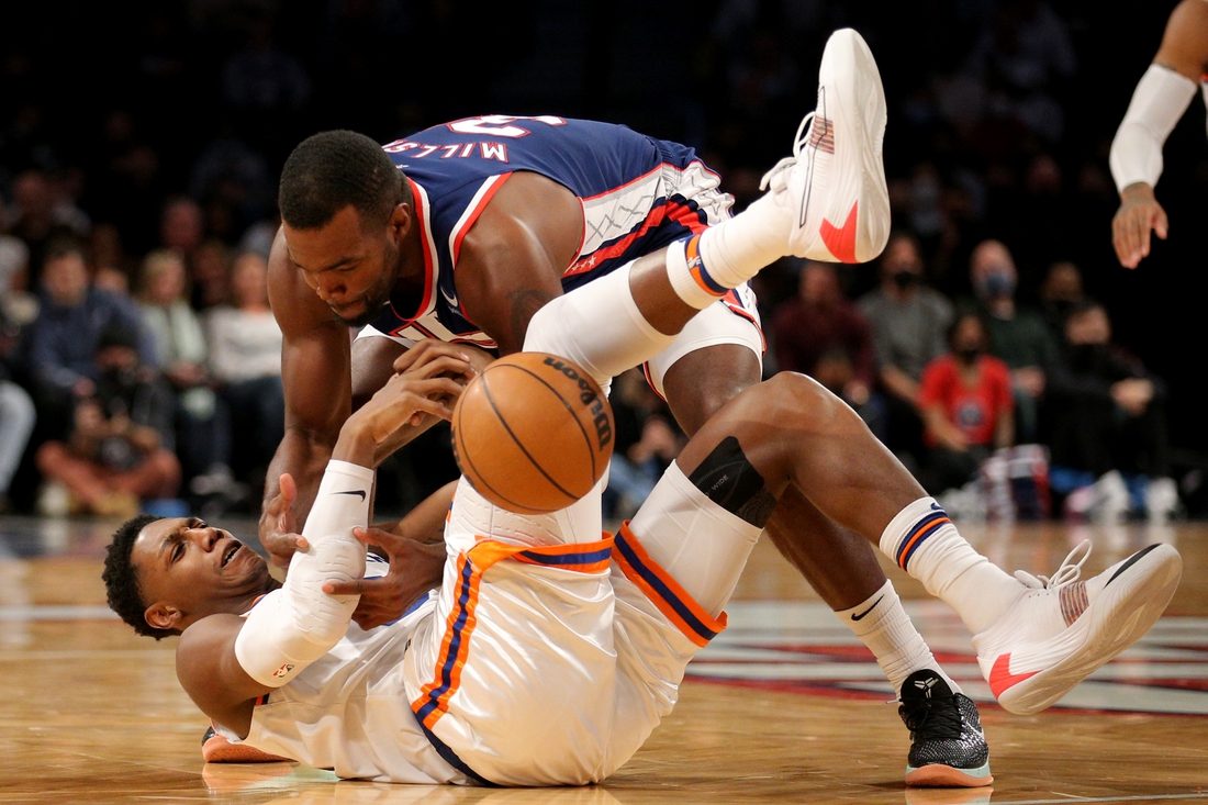 Nov 30, 2021; Brooklyn, New York, USA; New York Knicks guard RJ Barrett (9) and Brooklyn Nets forward Paul Millsap (31) fight for possession during the second quarter at Barclays Center. Mandatory Credit: Brad Penner-USA TODAY Sports