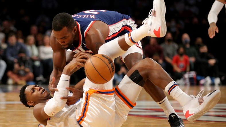 Nov 30, 2021; Brooklyn, New York, USA; New York Knicks guard RJ Barrett (9) and Brooklyn Nets forward Paul Millsap (31) fight for possession during the second quarter at Barclays Center. Mandatory Credit: Brad Penner-USA TODAY Sports