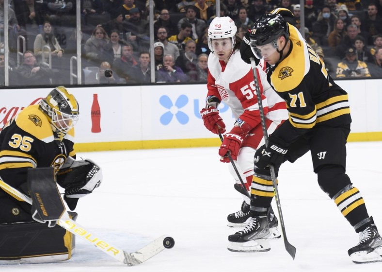 Nov 30, 2021; Boston, Massachusetts, USA;  Boston Bruins goaltender Linus Ullmark (35) makes a save in front of Detroit Red Wings left wing Tyler Bertuzzi (59) and left wing Taylor Hall (71) during the second period at TD Garden. Mandatory Credit: Bob DeChiara-USA TODAY Sports