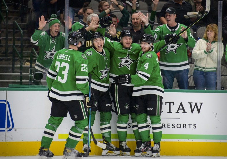 Nov 30, 2021; Dallas, Texas, USA; Dallas Stars defenseman Esa Lindell (23) and left wing Jason Robertson (21) and left wing Roope Hintz (24) and defenseman Miro Heiskanen (4) celebrates a second goal scored by Hintz against the Carolina Hurricanes during the second period at the American Airlines Center. Mandatory Credit: Jerome Miron-USA TODAY Sports