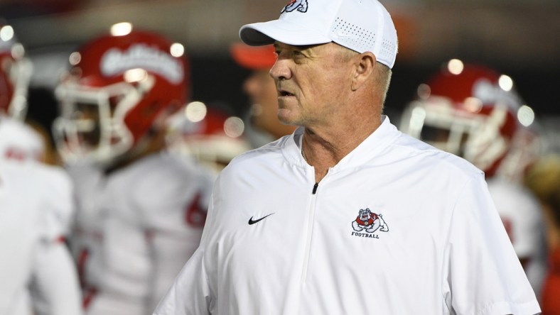 Sep 15, 2018; Pasadena, CA, USA; Fresno State Bulldogs head coach Jeff Tedford watches his team run pregame drills during warmups before a game against the UCLA Bruins at the Rose Bowl. Mandatory Credit: Robert Hanashiro-USA TODAY Sports