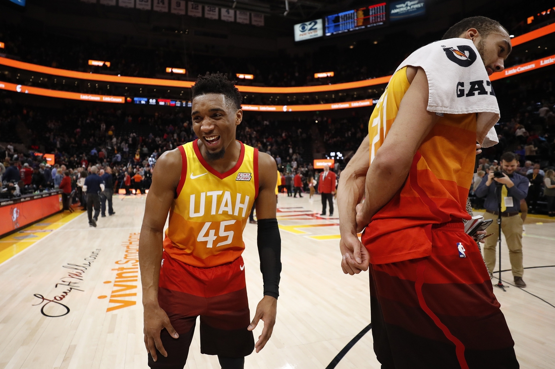 Jan 14, 2019; Salt Lake City, UT, USA; Utah Jazz guard Donovan Mitchell (45) reacts after distracting teammate Rudy Gobert (27) during  a postgame interview after their win against the Detroit Pistons at Vivint Smart Home Arena. Mandatory Credit: Jeff Swinger-USA TODAY Sports
