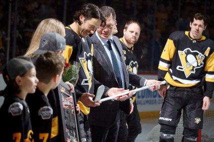 Mar 5, 2019; Pittsburgh, PA, USA;  Pittsburgh Penguins assistant general manager Bill Guerin (RC) presents center Matt Cullen (7) with an aluminum stick to commemorate Cullen's 1,500th career NHL game played before the game against the Florida Panthers at PPG PAINTS Arena. Mandatory Credit: Charles LeClaire-USA TODAY Sports